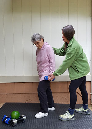 Picture of woman trainer working with older woman